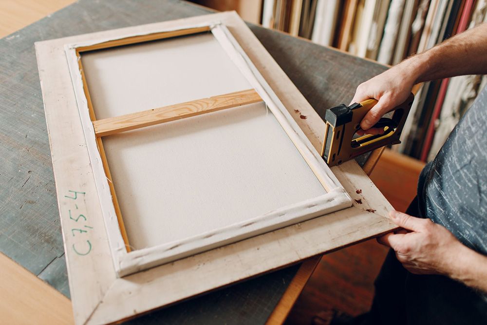 Person stapling a frame